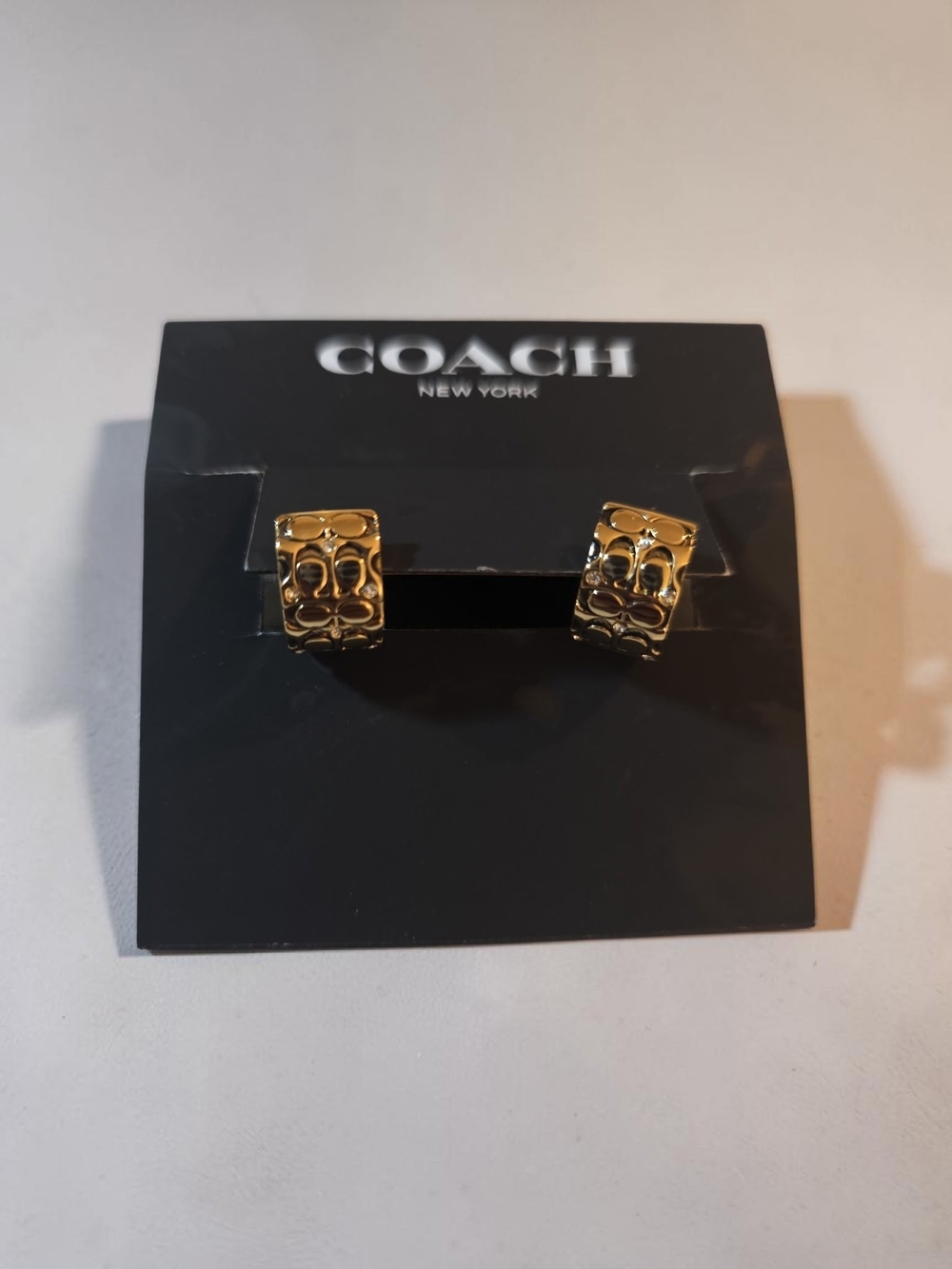 Coach Gold-Tone Signature Pattern Huggie Earrings